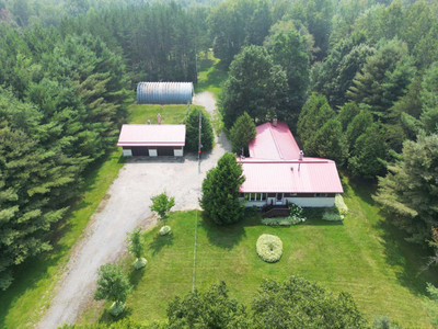 Nearly 9 Acre Oasis with Charming Bungalow, Barns, and Gardens